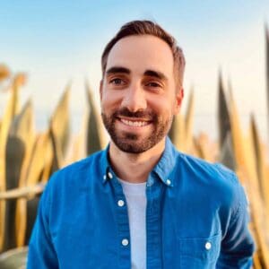 A man in a blue shirt standing in front of cactus during MC Fireside Chats on January 11, 2023.