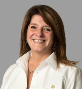 A woman in a white shirt smiling during the MC Fireside Chats on January 17th, 2024.